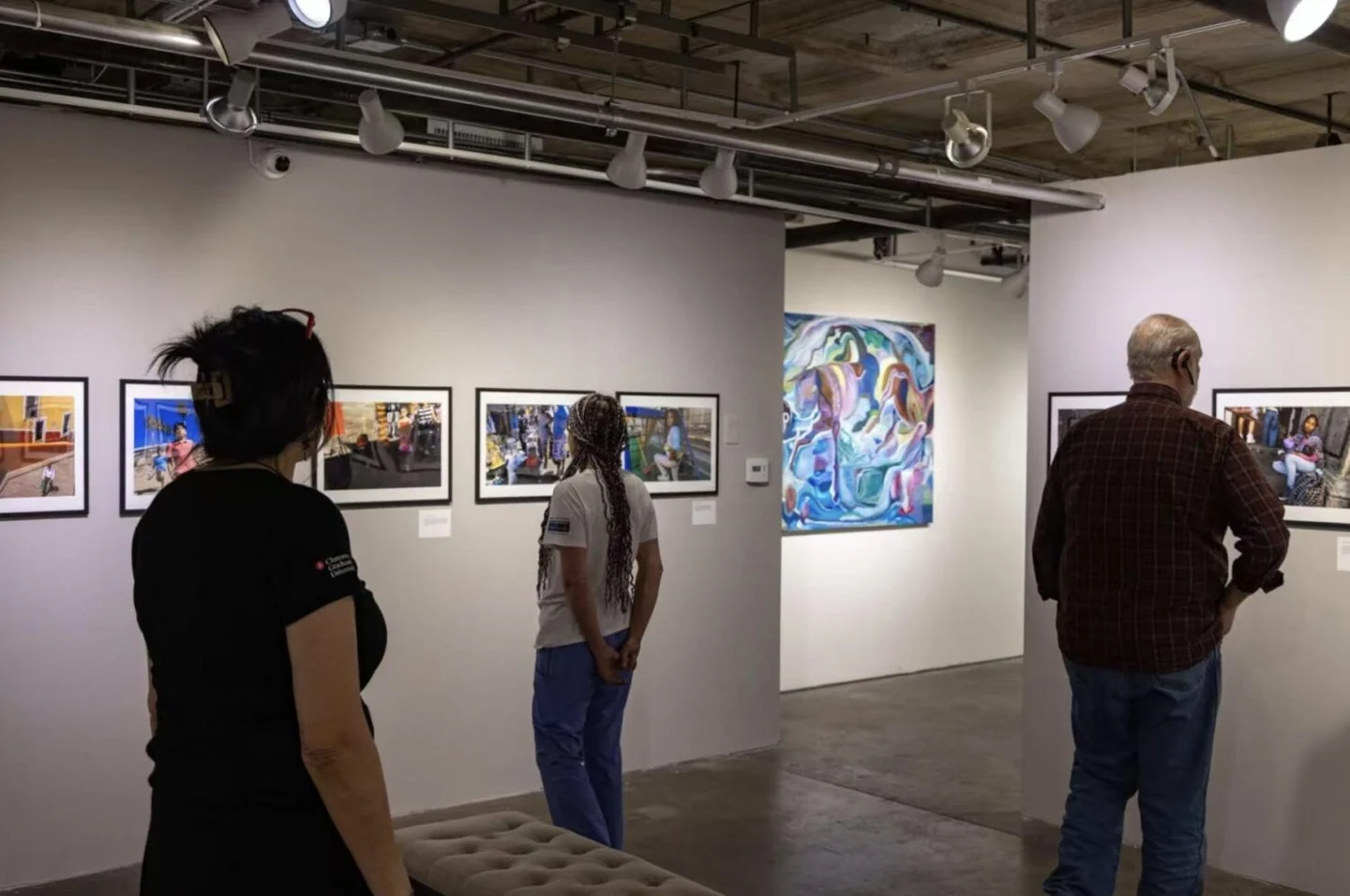 Visitors viewing photographic works in an exhibition space